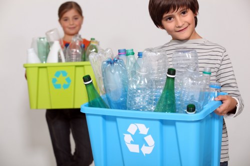 Recycling bins and materials being sorted